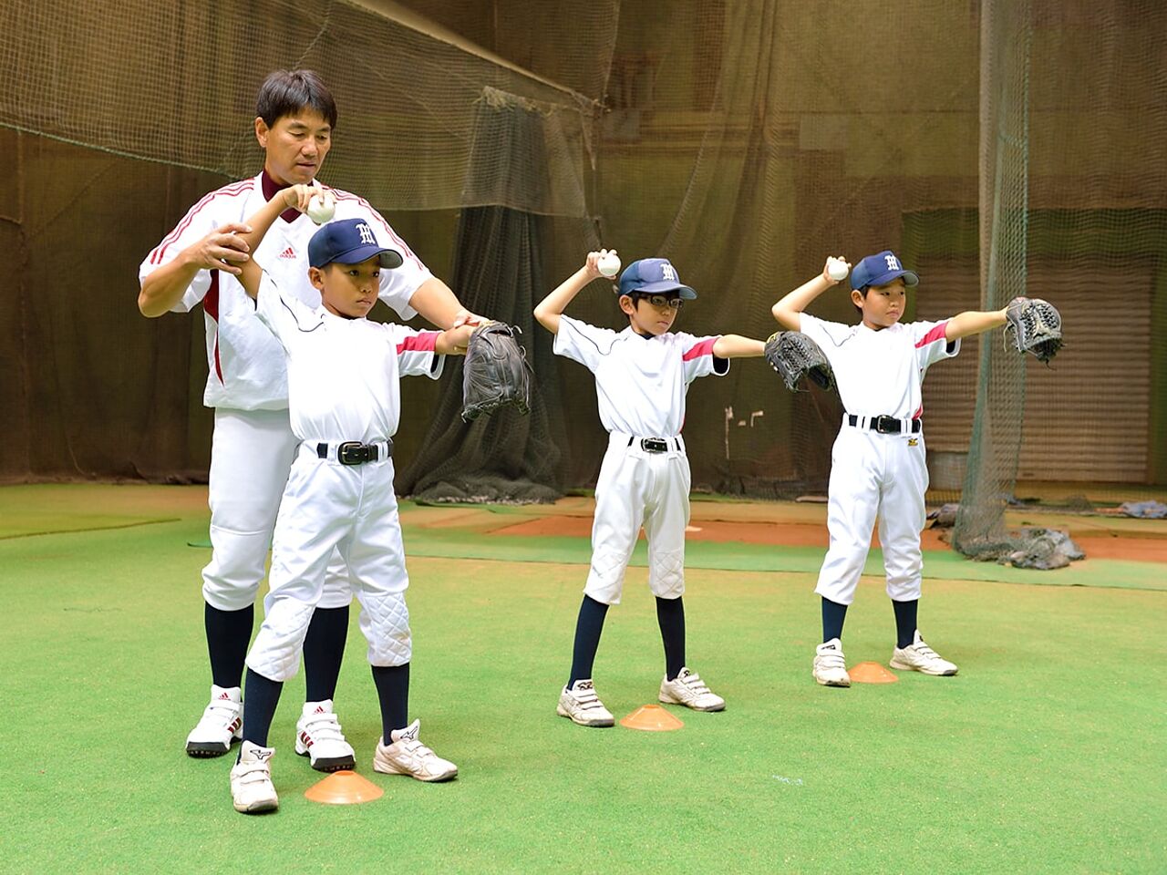 大石さんが子どもたちと野球の練習をおこなう様子が分かる画像
