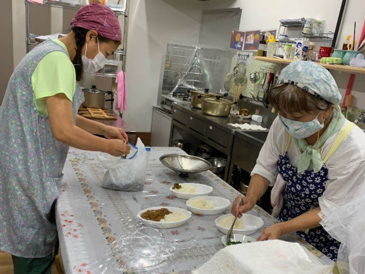 スタッフの女性2人がご飯を作っている画像