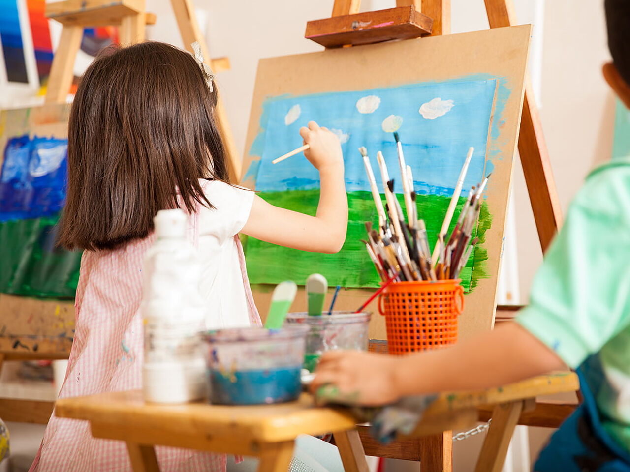 男女の子ども二人が絵を描いている画像